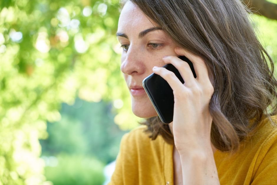 Person making a phone call outdoors